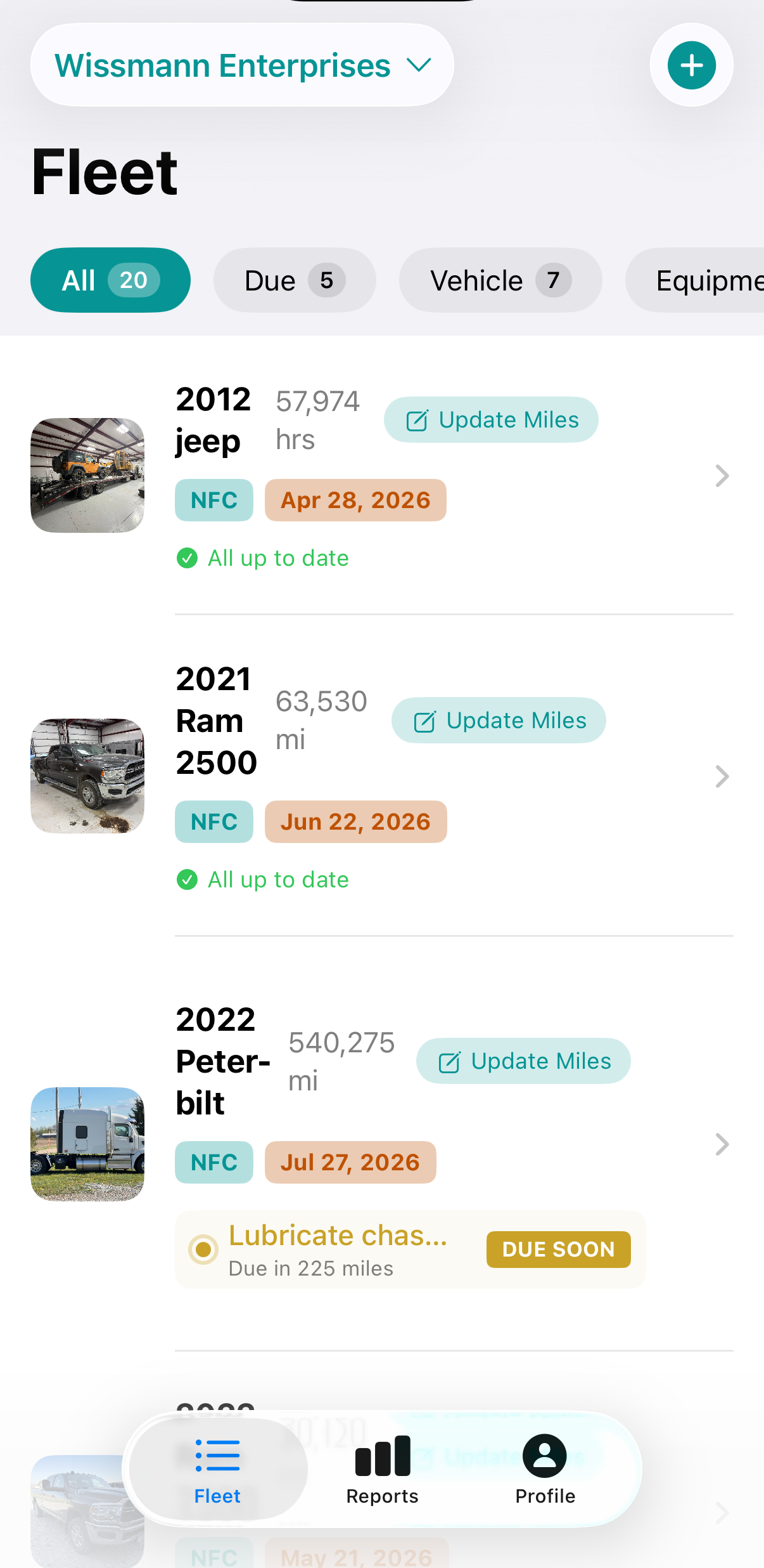 QuickTrack Fleet screen showing vehicles with photos, mileage, NFC tags, and maintenance status